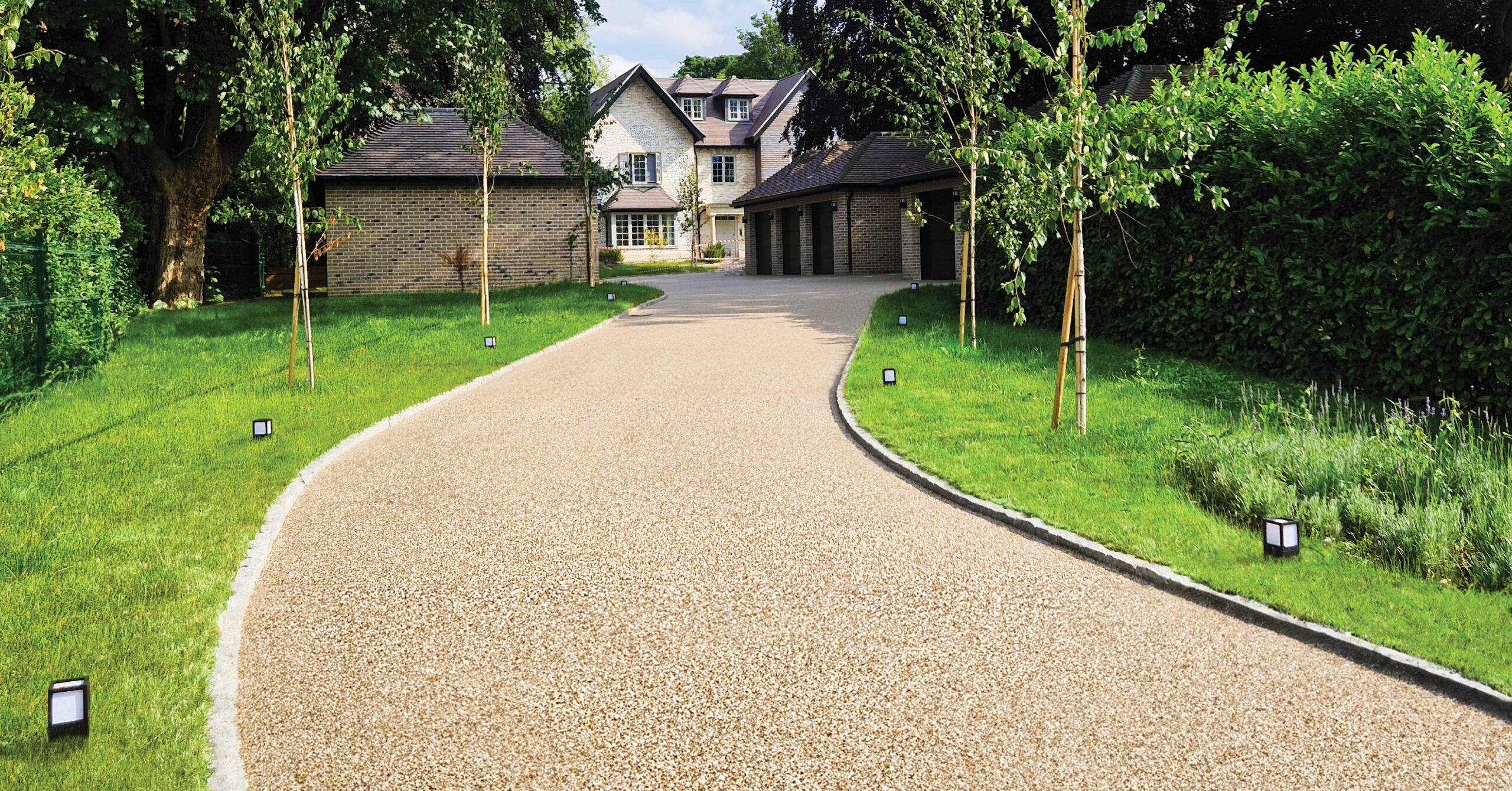 Aspirational driveway laid with Addagrip's Addaset in Scandinavian Bronze style.