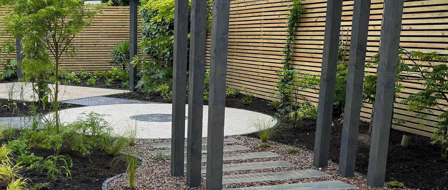 Banner image of Stonebound Icicle installation in a residential garden.